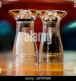 Salt and Pepper grinders on an oak table Stock Photo