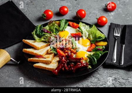 Great breakfast with fried eggs, toast, lettuce and tomato. Photographed in the vicinity Stock Photo