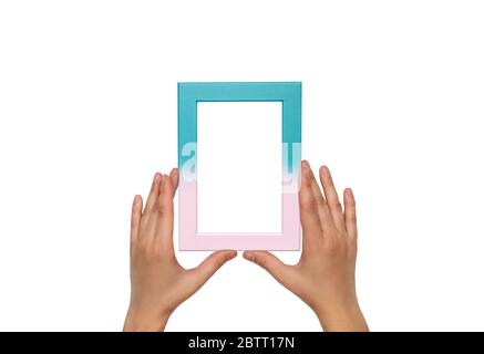 Blue with pink frame. Photo frame in female hands. Empty pink and blue frame template. Stock Photo