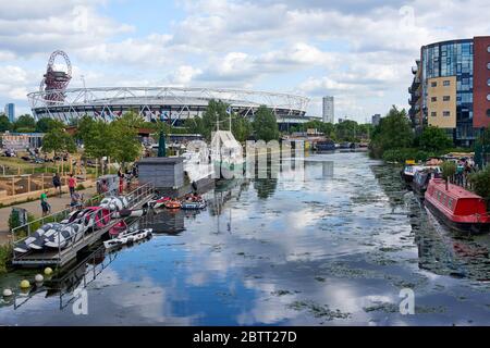Boats along the River Lea Navigation at Hackney Wick, East London UK, looking towards the London Stadium and the Olympic Park Stock Photo
