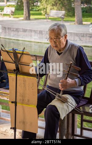 Grandfather playing Chinese traditional musical instrument Kuaiban ...