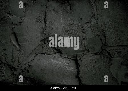 Dark wall in cement mortar. Cracked exterior texture background Stock Photo