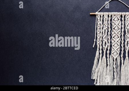 handmade macrame on black background, place for text, banner, flat layout, top view, hobby, creativity, copy space Stock Photo