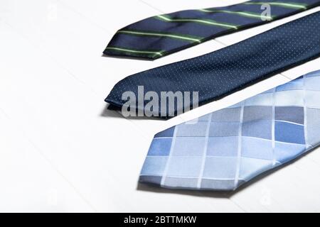 Men's ties on a white wooden background. Place for text Stock Photo