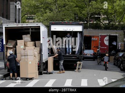 New York, United States. 27th May, 2020. Moving trucks, workers and boxes dominate a street on the Upper West Side of Manhattan in the days of the Coronavirus Pandemic in New York City on Wednesday, May 27, 2020. New Yorkers cannot be evicted for failing to pay their rent amid the coronavirus crisis. Gov. Andrew M. Cuomo recently announced a 60-day extension through August 20 of a moratorium that was scheduled to end in June. More than 5.5 million cases of COVID-19 have been reported worldwide resulting in over 345,000 deaths. Photo by John Angelillo/UPI Credit: UPI/Alamy Live News Stock Photo