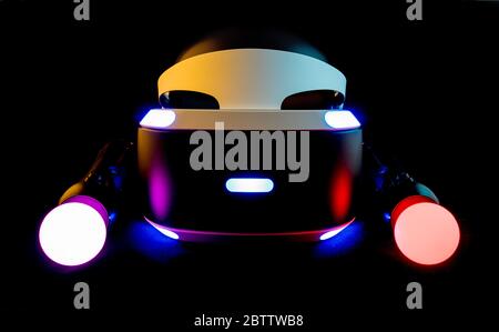 Playstation Virtual Reality System, PSVR with Move motion controllers lit up against a black background. Stock Photo