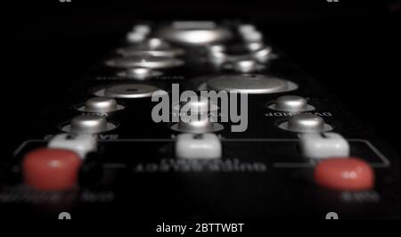 TV remote control with blurry out of focus buttons Stock Photo