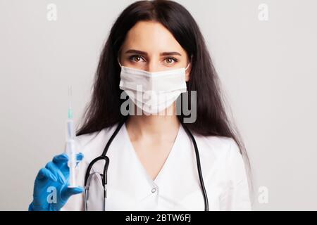 Medicine concept, female doctor typed in syringe vaccine for injection Stock Photo
