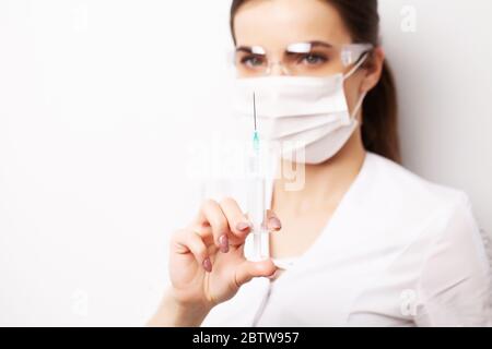 Medicine concept, female doctor typed in syringe vaccine for injection Stock Photo