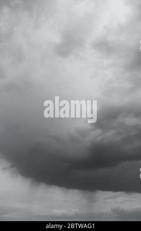 Vertical photo of rain clouds over horizon. Dark cloudy stormy sky with clouds. Stock Photo