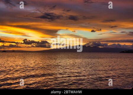 Amazing fiery sunset from the shores of Maui out to the nearby islands of Lanai and Molokai. Stock Photo