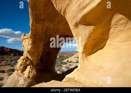 NV00130-00...NEVADA - A window through sandstone buttress viewed along the White Domes Loop Trail in Valley of Fire State Park. Stock Photo