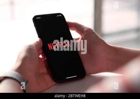 CHIANG MAI, THAILAND, NOV 17, 2019: Woman Smart Phone with Netflix iPhone Xs. Stock Photo