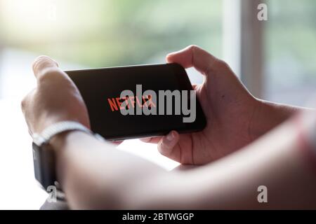 CHIANG MAI, THAILAND, NOV 17, 2019: Woman holding Smart Phone Netflix Phone Xs. Stock Photo