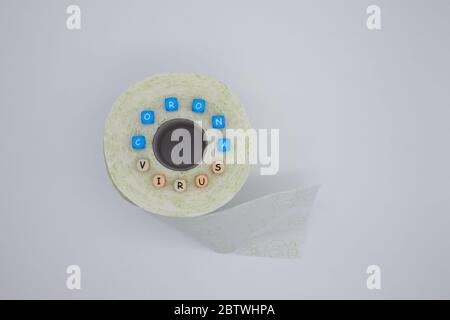 Corona virus with letter cubes on greenish toilet paper Stock Photo