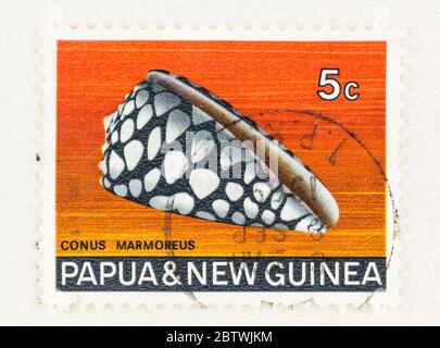 SEATTLE WASHINGTON - May 25, 2020:  Marbled Cone snail on Papua and New Giunea 5 cent stamp. Scott # 268 Stock Photo