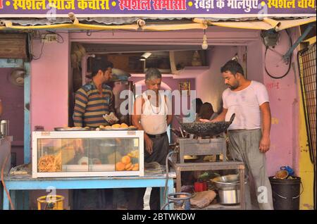 A man selling kachori, an Indian snack in his shop. Stock Photo