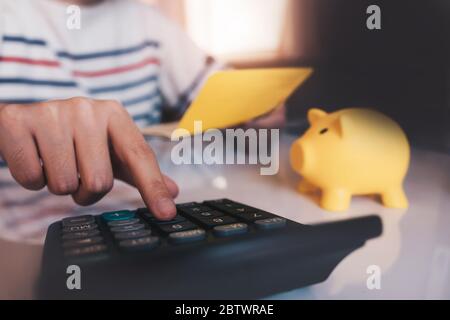 Business hands holding saving account passbook with calculator, account and saving Stock Photo