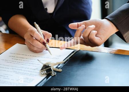 Real estate agent offer hand for customer sign agreement contract signature for buy or sell house. 