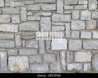Closeup of grey rectangular Italian style Stone Block wall Stock Photo