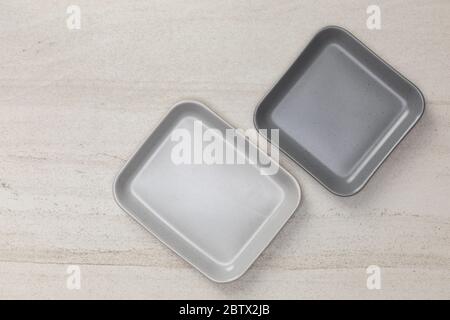 Group of empty blank ceramic square plates on white stone blackground, Top view of traditional handcrafted kitchenware concept Stock Photo