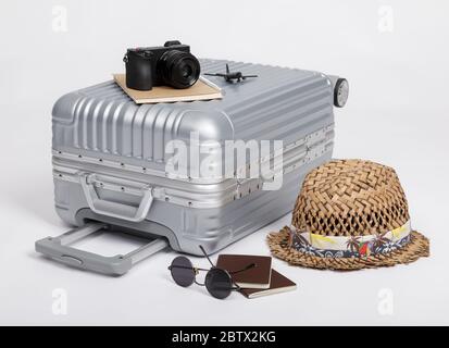 Travel Baggage with passport, camera, hat, airplane toy isolated on white background with copy space, Travel concept background Stock Photo