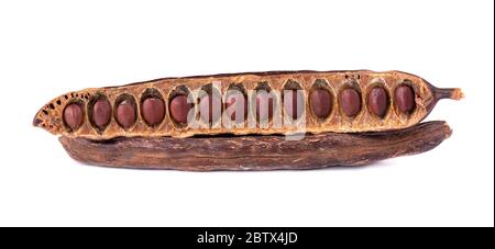 Ripe carob pods and bean isolated on white background. Stock Photo