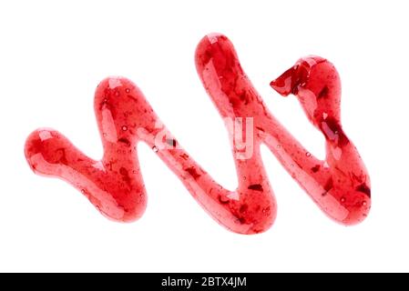 Cherry jam drizzle isolated on white background. Splashes of red berry jam. Top view. Stock Photo