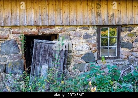Old abandoned house with a broken door Stock Photo