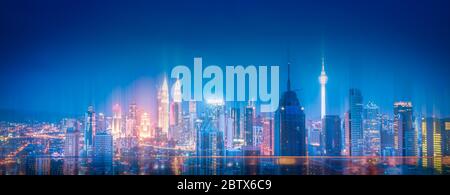 Kuala Lumpur city skyline with wireless network connection at night in Malaysia. Abstract communication technology concept Stock Photo