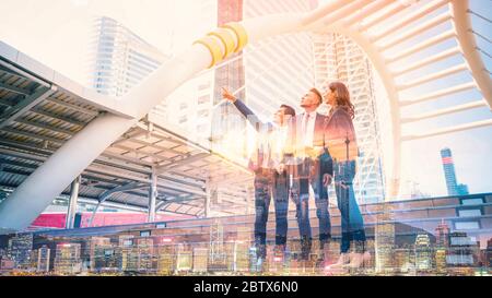 Abstract double exposure image of businessteam pointing up the future on blurred city background. Business success concept Stock Photo