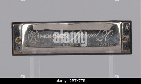 Harmonica used by Arthur Lee. A metal and plastic harmonica used by Arthur Lee. The harmonica is etched with lettering on the top and bottom. The lettering on the top of the harmonica reads “HOHNER Special 20 / MARINE BAND.” The letter “A” is etched on the top right side of the harmonica. Stock Photo