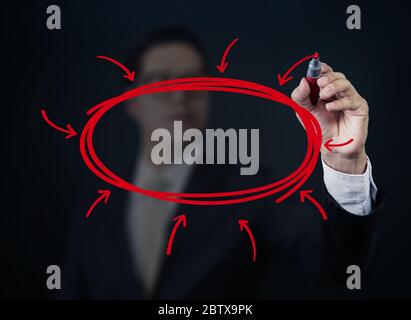 Businessman hand writing somting with red marker on transparent board, new business concept, studio shot Stock Photo