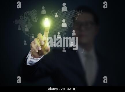 Businessman holding a transparent screen with teamwork. Business, technology, internet and networking concept. Stock Photo