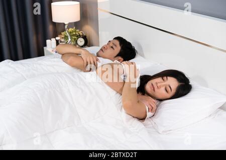 sick couple feeling cold and suffering from virus disease and fever on bed at home Stock Photo