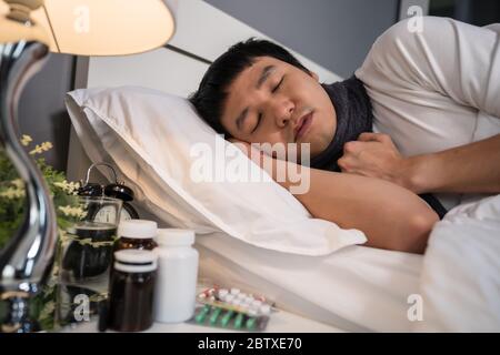 sick man sleeping in a bed Stock Photo
