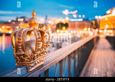 Stockholm, Sweden. Skeppsholmsbron - Skeppsholm Bridge With Its Famous Golden Crown In Night Lights. Famous Popular Place Landmark Destination. Scandi Stock Photo