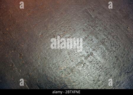 gray-reddish-colored stone background or texture; Surface of the gray-reddish stone wall for use as a background. Stock Photo