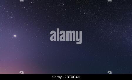 Night Starry Sky With Glowing Stars. Bright Glow Of Planet Venus In Sky Among The Stars. Starry Backdrop Background. Stock Photo