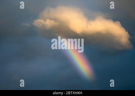 Beautiful rainbow spectrum in the sky after rain. Colourful phenomena in the clouds. Nobody Stock Photo
