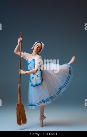 Young and graceful female ballet dancer as Cindrella fairytail character on studio background. Art, motion, action, flexibility, inspiration concept. Flexible ballerina in inspired dancing. Stock Photo