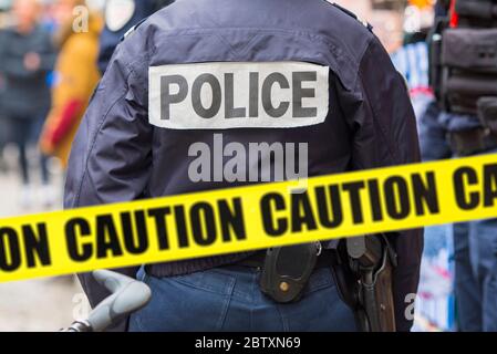 Police man and yellow tape, crime scene, caution - adhesive tape. Concept picture Stock Photo