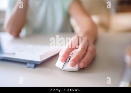 the developer works at computer, uses the mouse Stock Photo