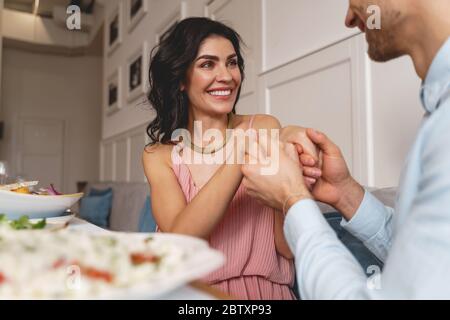 Happy young woman spending time with gentleman in cafe Stock Photo