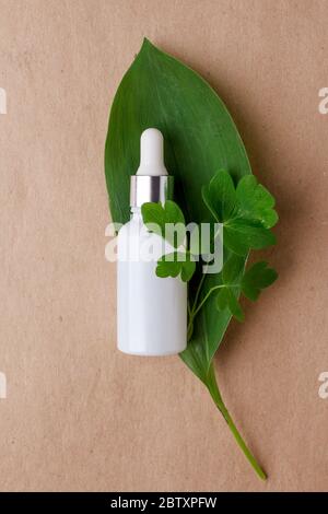 Natural Serums in white glass bottle. Concept of cosmetic injection is hyaluronic acid, botulin, serum, natural ingredients, natural calming tones, su Stock Photo