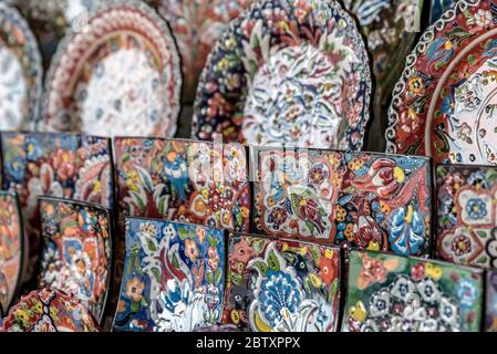 Beautiful, colorful ceramic plates, for sale in a Dubai Souk. The plates have finely detailed, Arabian patterns on them