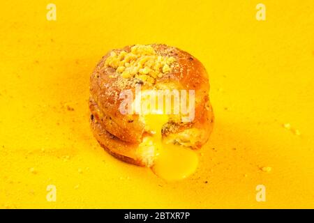 Lemon blueberry filled doughnut on yellow background Stock Photo