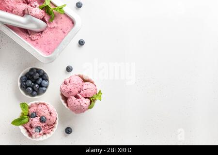 Berries ice cream in bowls on white background. Space for text. View from above. Stock Photo