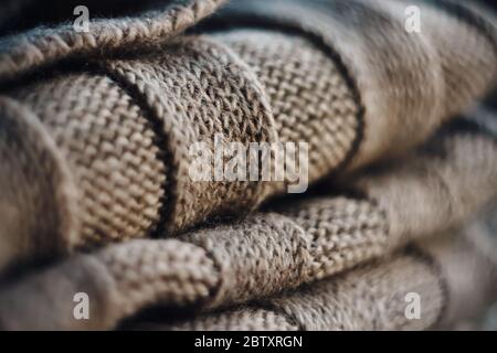 A warm beige wool blanket lies folded in a pile for the cold season. Stock Photo