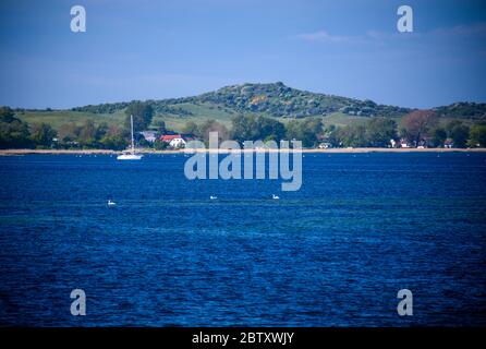 Vitte, Germany. 25th May, 2020. The Baltic Sea island of Hiddensee can be seen from the Baltic Sea. Credit: Jens Büttner/dpa-Zentralbild/ZB/dpa/Alamy Live News Stock Photo